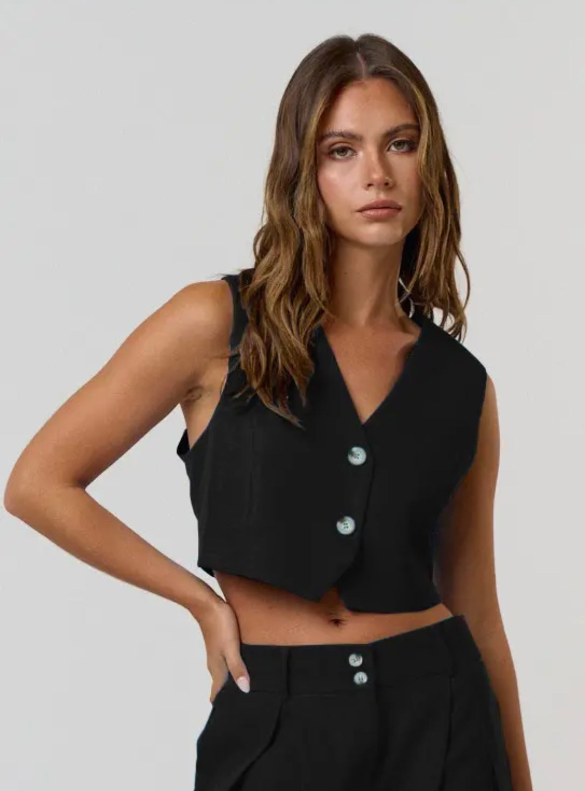 Blue Blush cropped black vest.